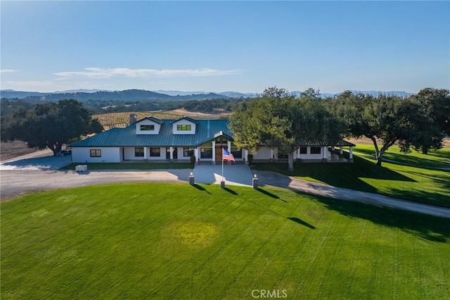 view of front of home with a mountain view and a front yard