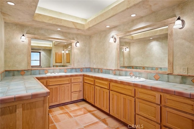 bathroom featuring vanity and a tray ceiling