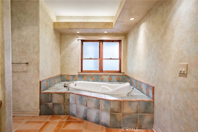 bathroom with tiled tub, breakfast area, and tile patterned flooring