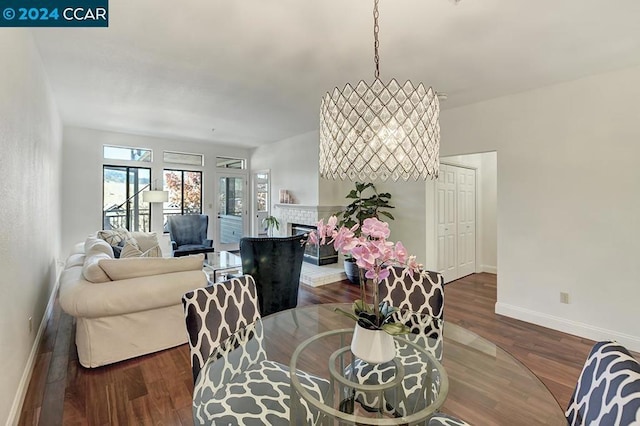 dining area featuring dark hardwood / wood-style floors and a tile fireplace