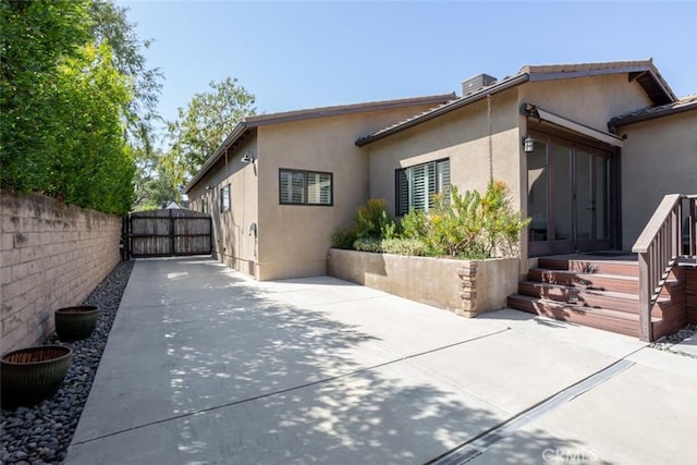 view of side of property featuring a patio