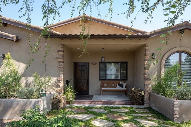 view of exterior entry featuring a porch