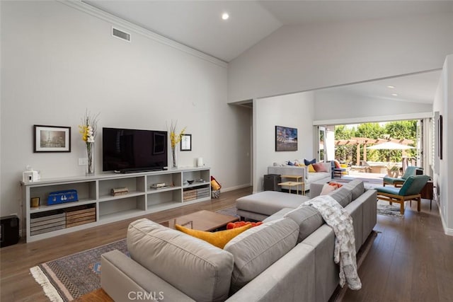 living room featuring dark hardwood / wood-style flooring, ornamental molding, and high vaulted ceiling