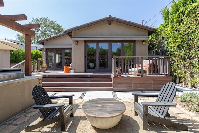 back of house with a patio and french doors