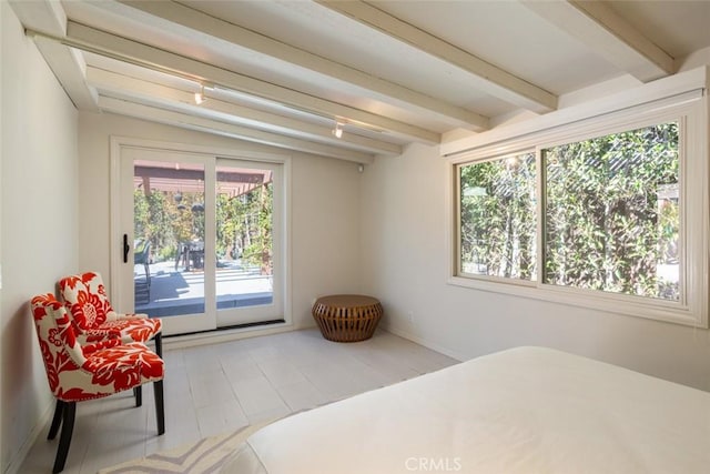 bedroom with access to exterior and vaulted ceiling with beams