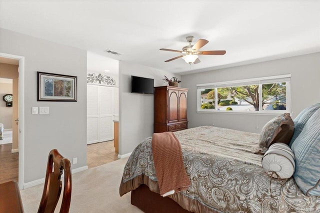 bedroom with ceiling fan and light colored carpet