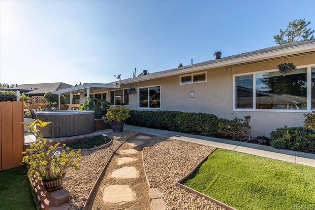 exterior space featuring cooling unit and a hot tub