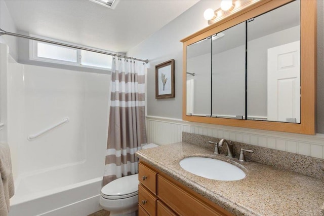 full bathroom featuring toilet, vanity, and shower / tub combo