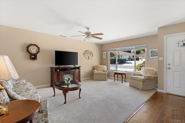 living room with hardwood / wood-style flooring and ceiling fan