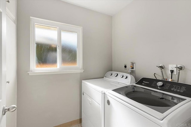 laundry room featuring washer and dryer and a healthy amount of sunlight