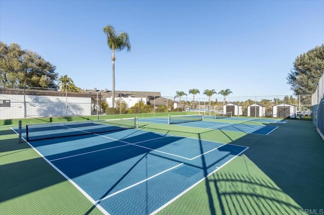 view of tennis court featuring basketball hoop