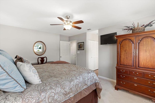 carpeted bedroom with a closet and ceiling fan