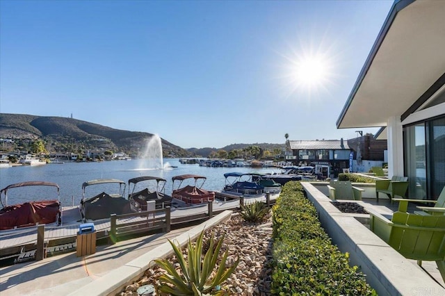 view of dock with a water and mountain view