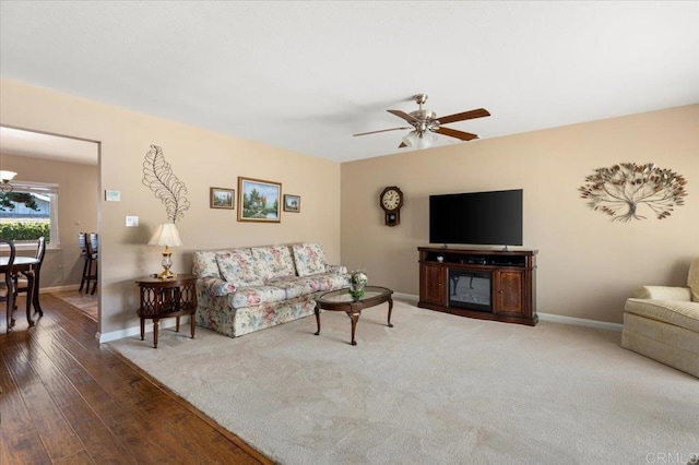 living room featuring wood-type flooring and ceiling fan