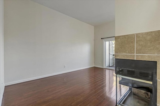 unfurnished living room with dark hardwood / wood-style floors