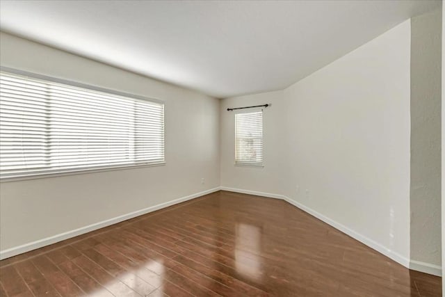 unfurnished room with dark hardwood / wood-style floors