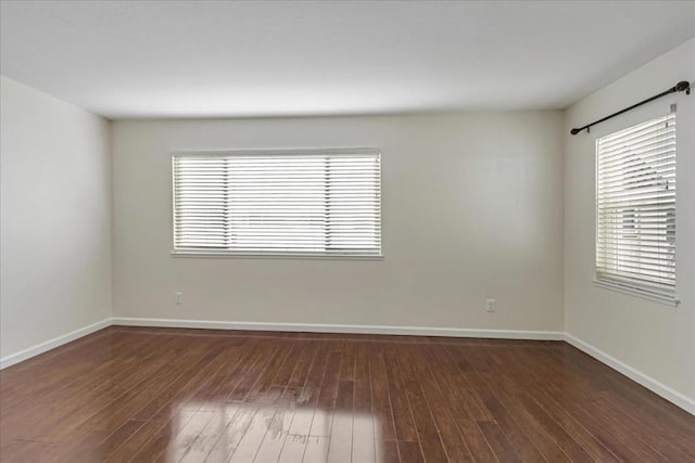 empty room with dark wood-type flooring