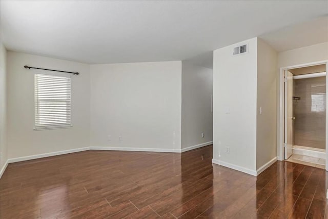 empty room featuring dark hardwood / wood-style flooring