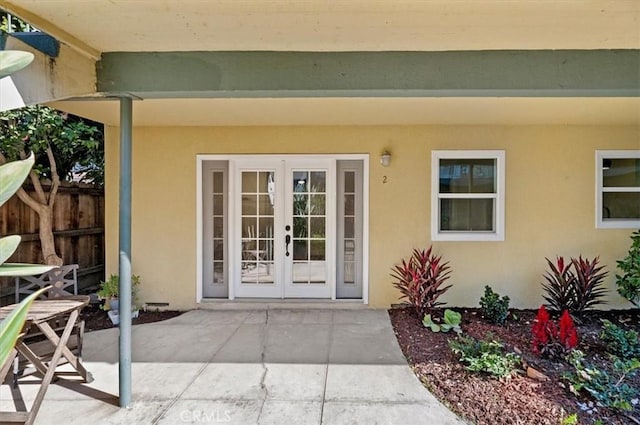 view of exterior entry featuring french doors and a patio