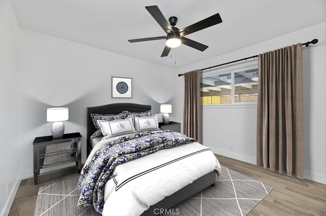 bedroom with ceiling fan and hardwood / wood-style flooring