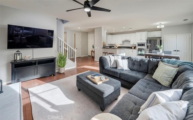 living room featuring hardwood / wood-style flooring and ceiling fan