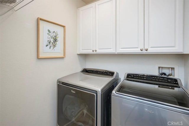 laundry room featuring cabinets and washing machine and dryer