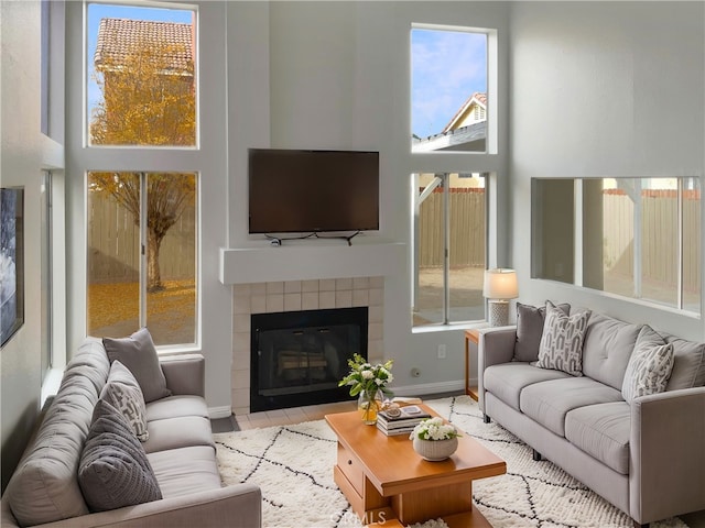 living room featuring a tile fireplace