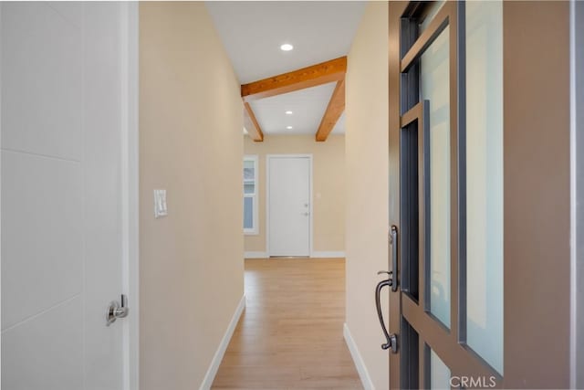 hall featuring vaulted ceiling with beams and light hardwood / wood-style floors