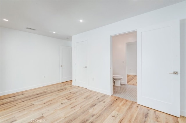 spare room with light hardwood / wood-style flooring