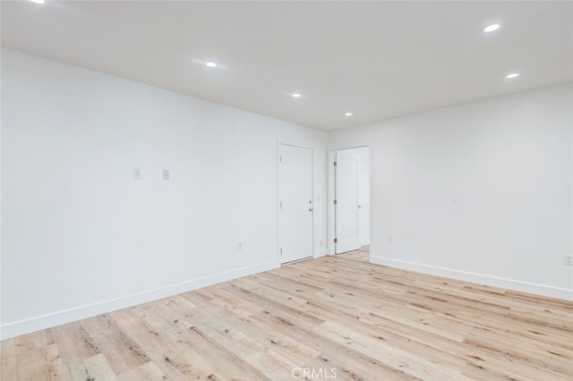 unfurnished room with light hardwood / wood-style floors