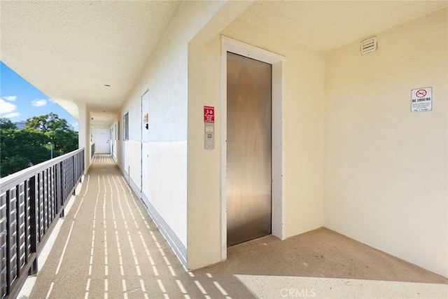 hallway featuring elevator