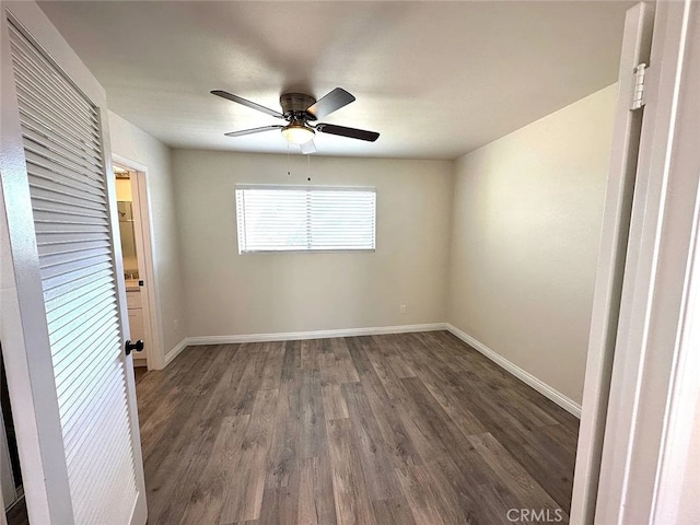 unfurnished room with ceiling fan and dark hardwood / wood-style flooring