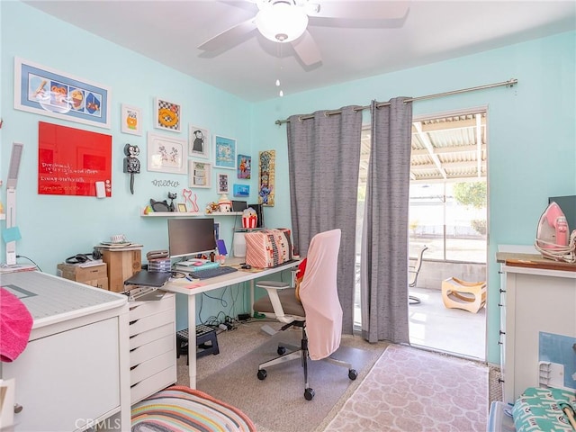 carpeted office space featuring ceiling fan