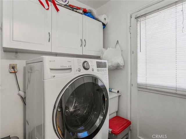 laundry area with cabinets and washer / dryer