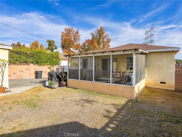 back of property with a sunroom