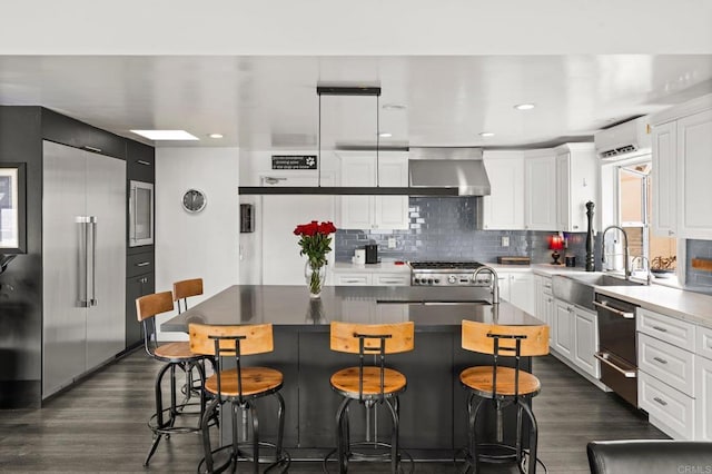 kitchen featuring a kitchen island, built in fridge, and white cabinetry