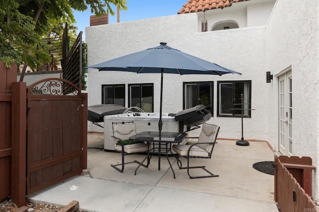 view of patio / terrace with a hot tub