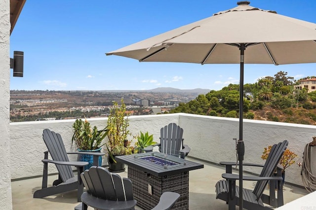 view of patio / terrace featuring a mountain view and a fire pit