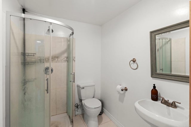 bathroom with walk in shower, tile patterned floors, sink, and toilet