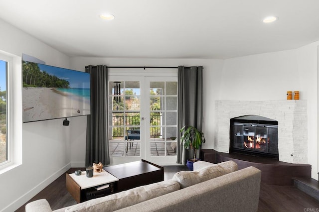 living room with french doors, a wealth of natural light, and dark hardwood / wood-style floors