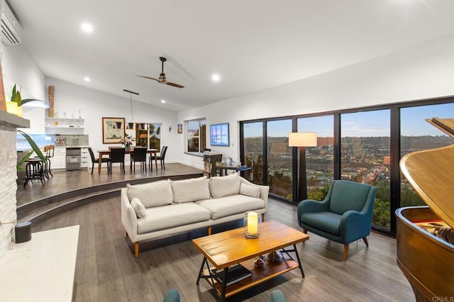 living room with hardwood / wood-style flooring, a wall unit AC, ceiling fan, and vaulted ceiling