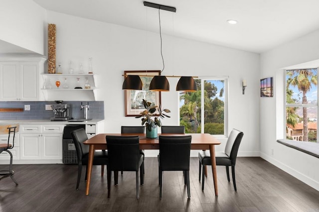 dining room featuring dark hardwood / wood-style flooring and vaulted ceiling