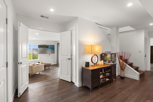 hallway with dark hardwood / wood-style flooring