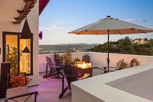 view of patio featuring a mountain view and a fire pit