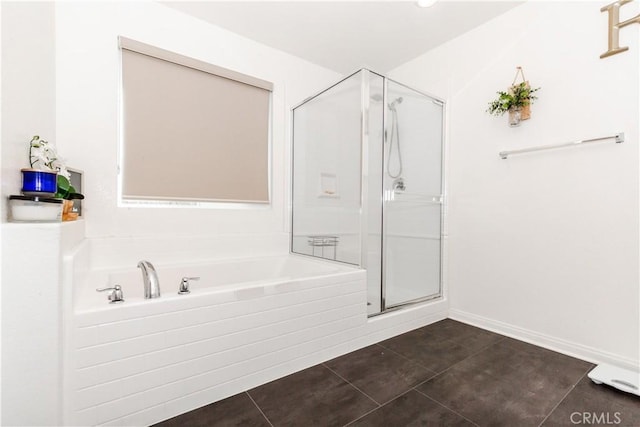 bathroom with tile patterned flooring, a stall shower, baseboards, and a garden tub