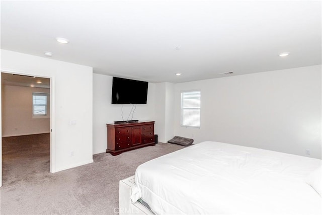 bedroom with recessed lighting, visible vents, and light carpet