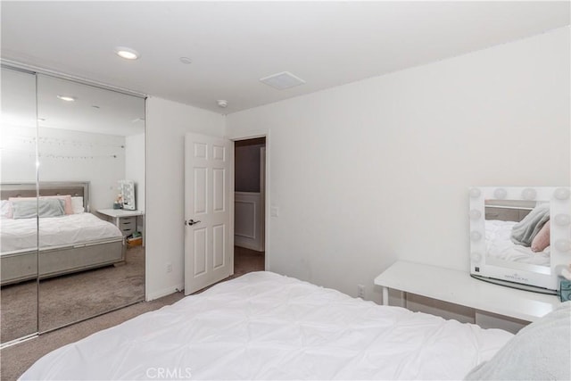 carpeted bedroom featuring a closet