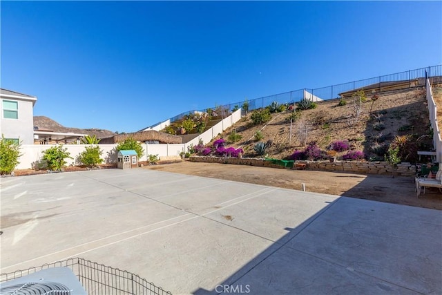 view of patio / terrace with a mountain view and a fenced backyard