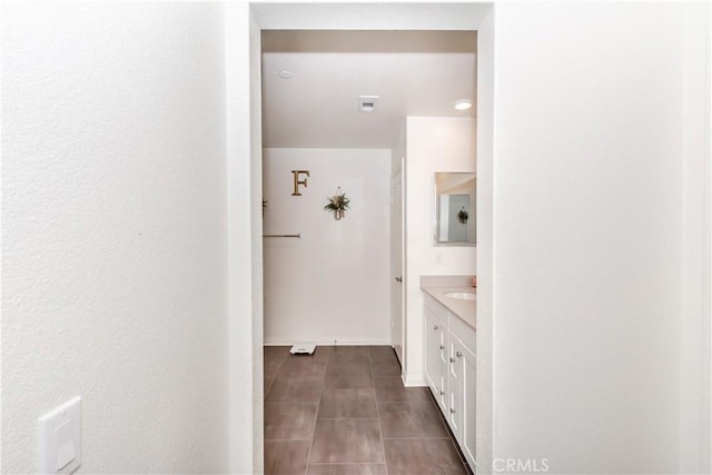 bathroom featuring visible vents, baseboards, and vanity