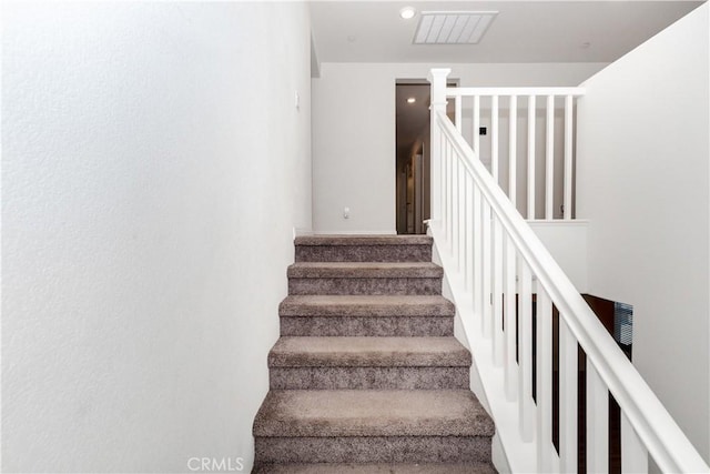 staircase featuring visible vents